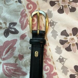 Black leather belt with gold buckle